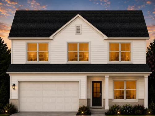 Modern two-story white house with black roof and warm-lit windows at sunset with landscaped front yard.