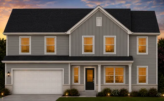 Two-story gray suburban house with white trim, black roof, illuminated windows, and front porch at sunset.